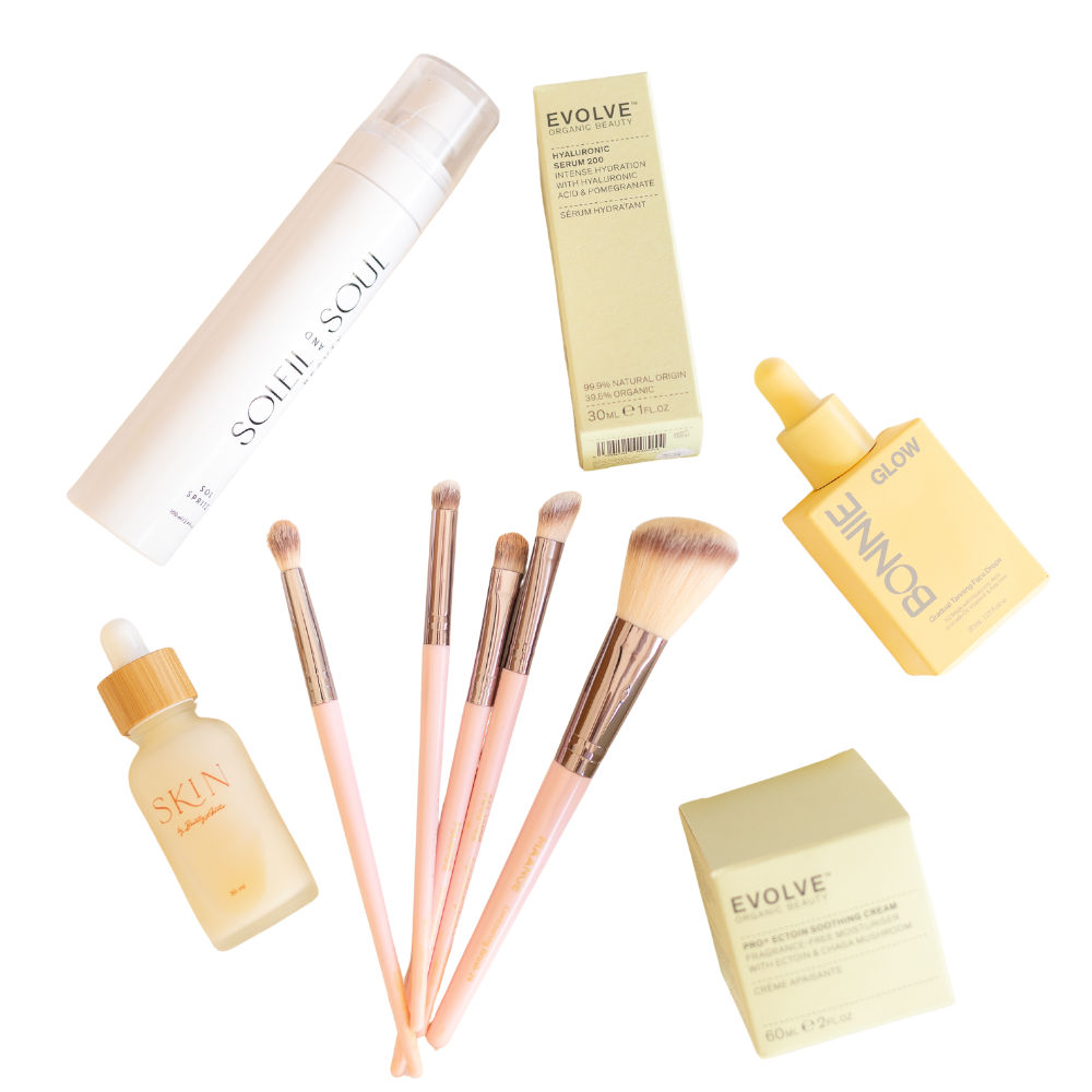 flay lay of beauty skincare products on a neutral background, including serums, moisturizes, sprays, cleansers, tanning drops and primer